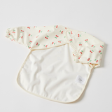 Back of Baby bib with cherry pattern on a light grey background