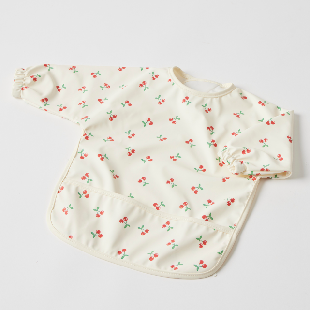 Baby bib with cherry pattern on a light gray background
