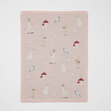 Pink blanket with animal illustrations on a white background
