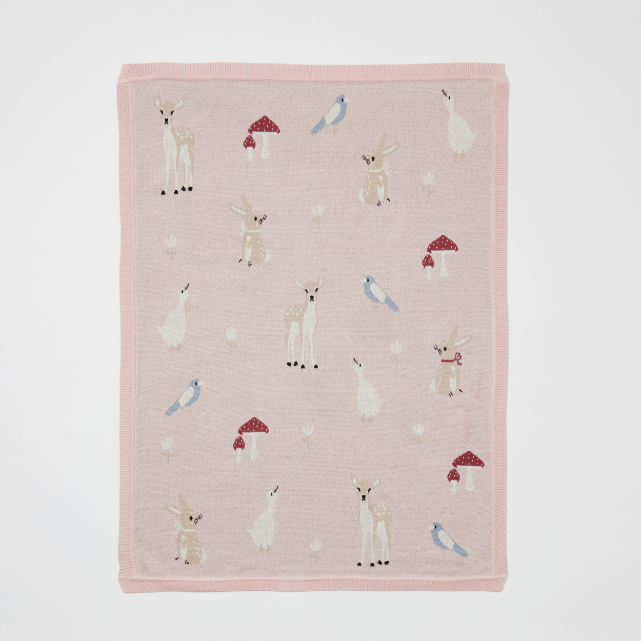 Pink blanket with animal illustrations on a white background
