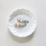 JOSIE JOAN'S Little Sage Hair Clips - Limited Edition on a white plate