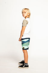 Side view of child wearing MUNSTER KIDS Waves Boardshort - Midnight