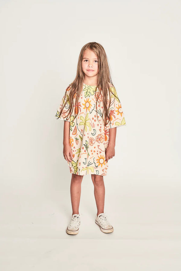 Girl wearing the MUNSTER KIDS Atoll Dress - Tropical Sand