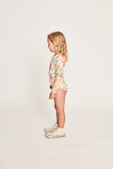Girl wearing MUNSTER KIDS Summer Paddlesuit - Tropical Sand side view