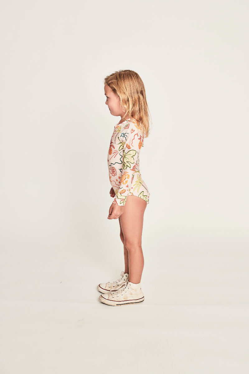 Girl wearing MUNSTER KIDS Summer Paddlesuit - Tropical Sand side view