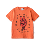 Orange t-shirt with a peace sign graphic and text on a white background