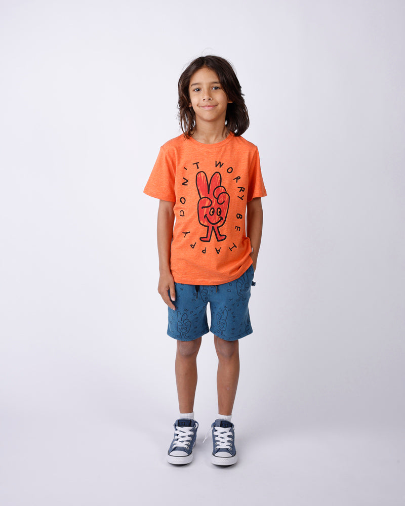 Child wearing an orange t-shirt with a graphic design on a white background