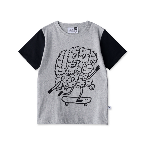 Gray t-shirt with black sleeves and a graphic of a fluffy creature on a skateboard on a white background