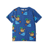 Blue t-shirt with pineapple and beach ball pattern on a white background