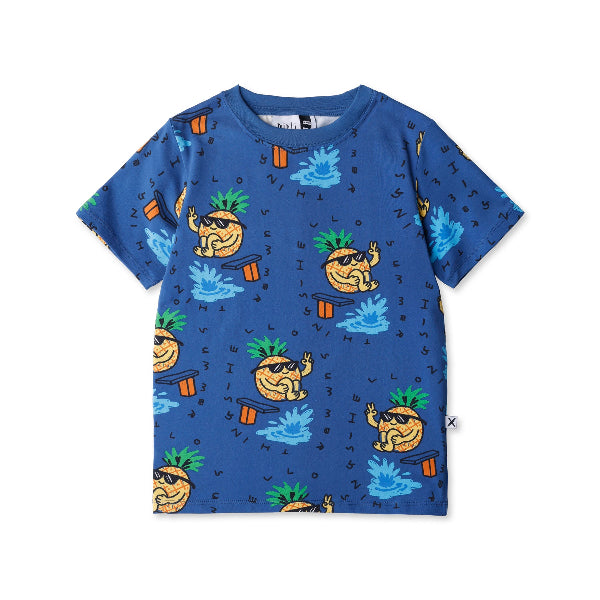 Blue t-shirt with pineapple and beach ball pattern on a white background