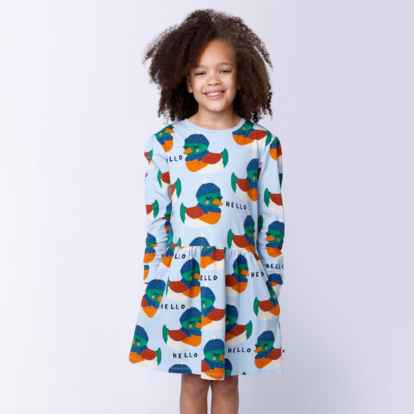 Child wearing MINTI Cosy Ducks Dress with hands in side pockets of dress