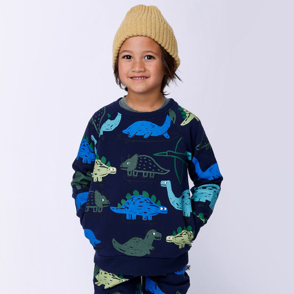Child wearing MINTI Dino Rollers Furry Crew with hands in pockets