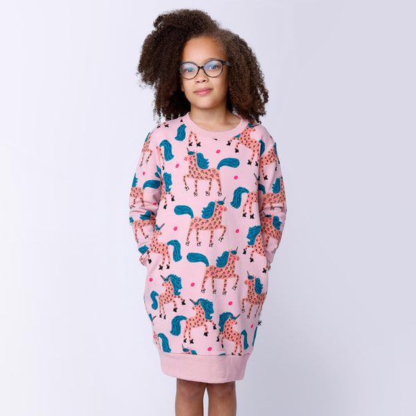 Child standing with hands in pockets of MINTI Dancing Unicorns Furry Dress