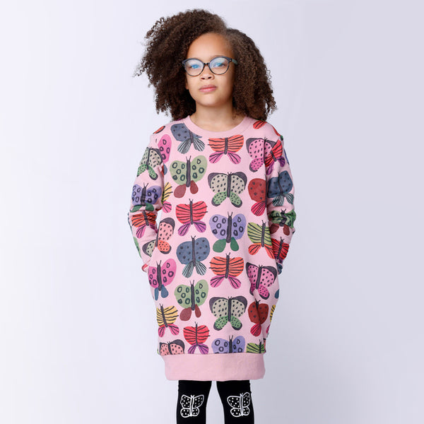 Child standing with hands in side pockets of dress - MINTI Flutter Furry Dress