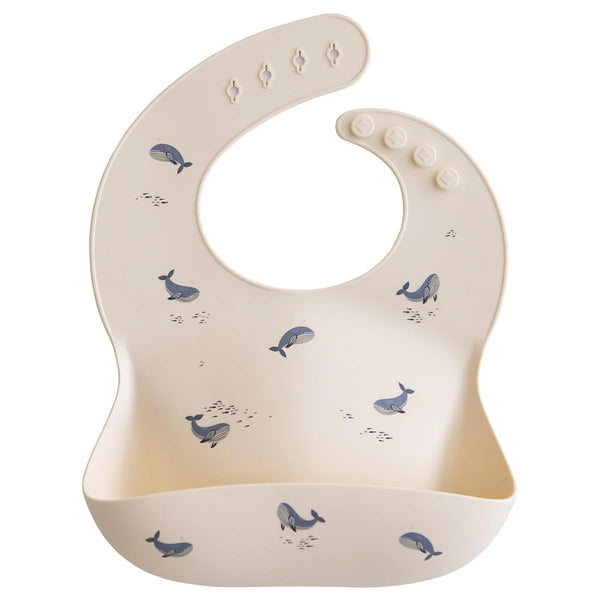 Baby bib with whale pattern on a white background