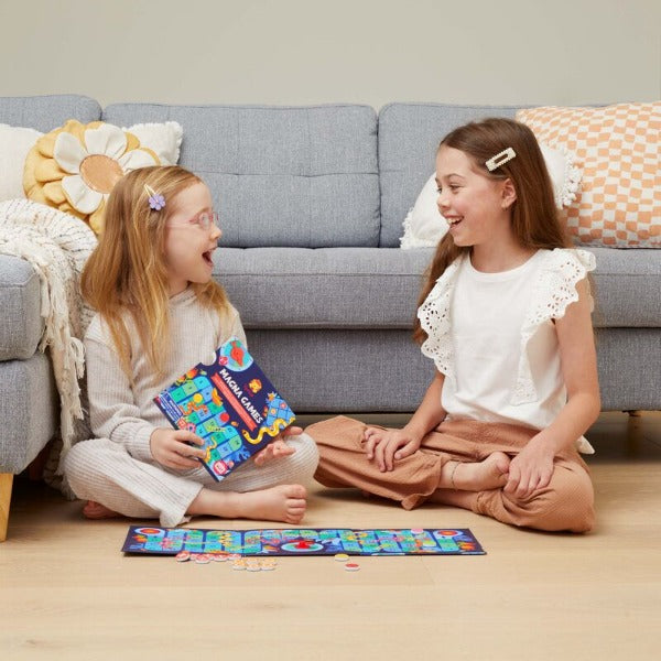 Girls sitting on floor playing Snakes & Ladders