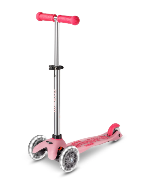 Pink scooter with silver accents on a white background