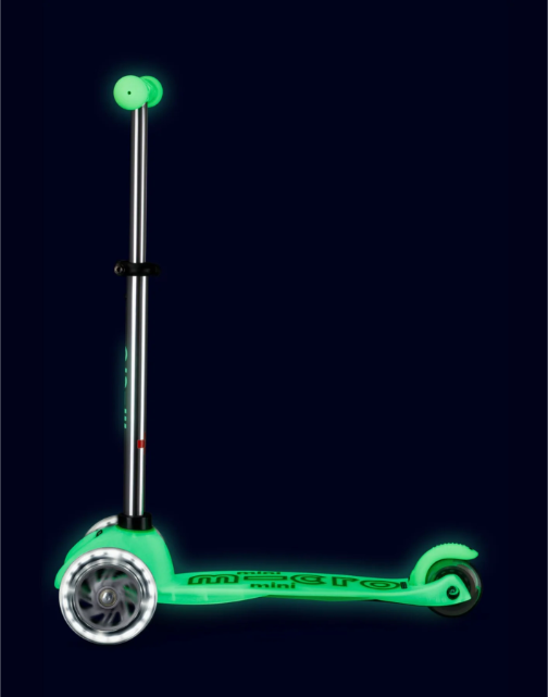 Glowing green scooter on a black background