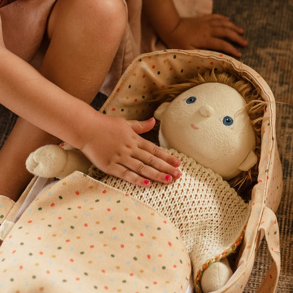 Dinkum doll lying in the OLLI ELLA Dinkum Dolls Carry Cot - Gumdrop