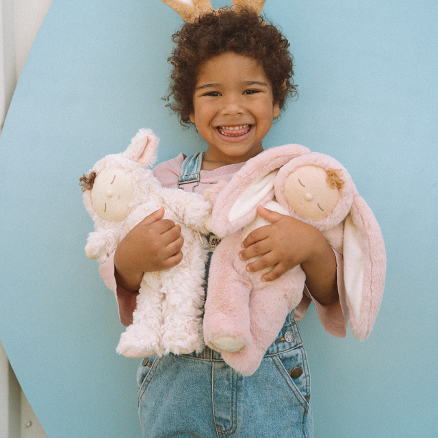 Child holding OLLI ELLA Cozy Dinkums Bunny Flopsy - Rose and Lamby Pookie