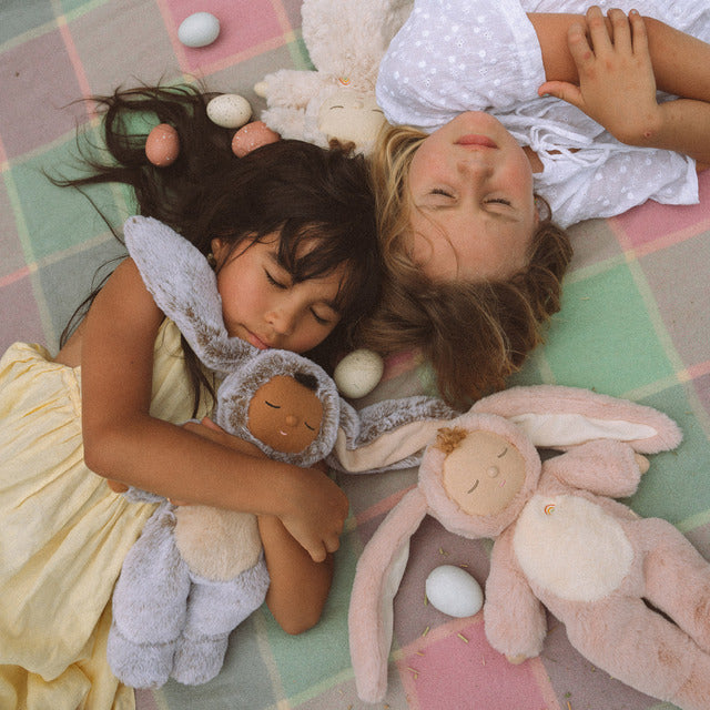 Kids lying down with OLLI ELLA Cozy Dinkums Bunny Flopsy - Rose and Bunny Muffin - Cocoa Cream