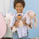 Child holding Cozy Dinkums: Lamby Pookie, Bunny Muffin and Bunny Flopsy 