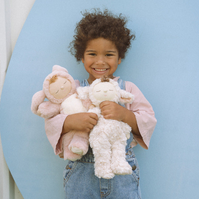 Child holding OLLI ELLA Cozy Dinkums Lamby Pookie - Vanilla and Bunny Flopsy - Rose
