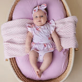 Baby in bassinet wearing the SNUGGLE HUNNY Coral Short Sleeve Organic Dress