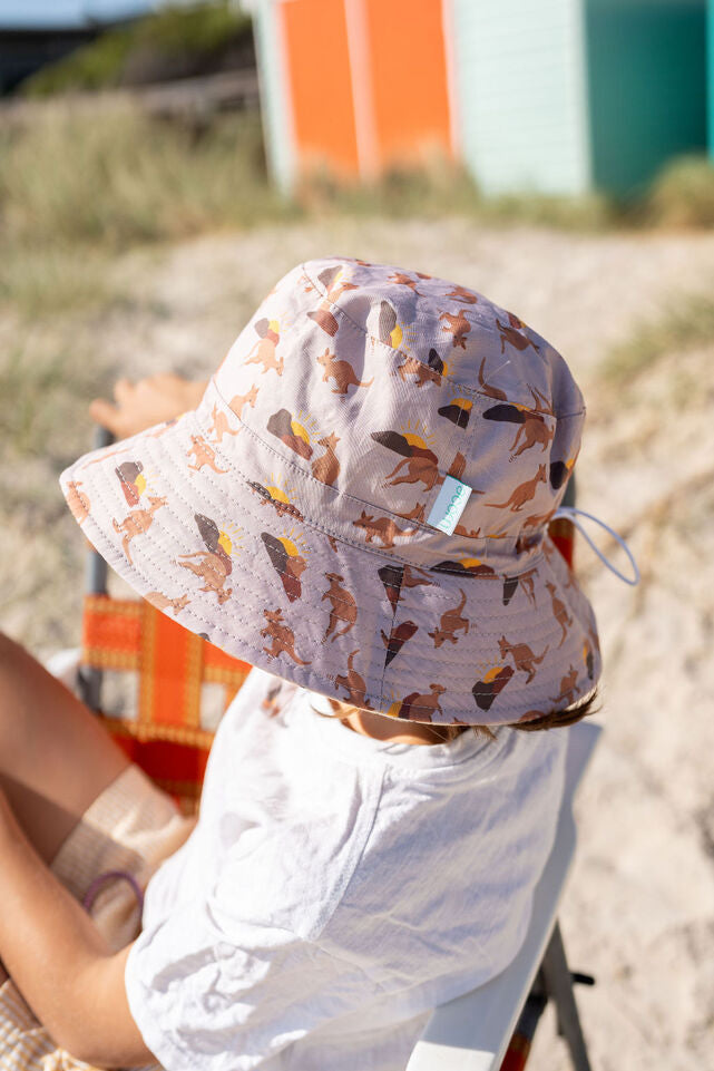 SIDE VIEW OF CHILD WEARING ACORN Aussie Sunset Wide Brim Bucket Hat