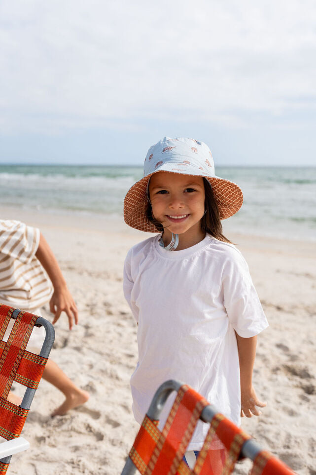 CHILD AT BEACH WEARING ACORN Echidna Wide Brim Bucket Hat