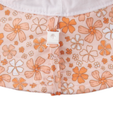 Floral-patterned fabric with orange and white flowers on a light pink background.