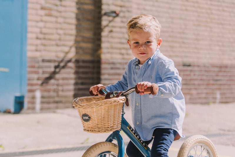 Boy riding a blue trybike