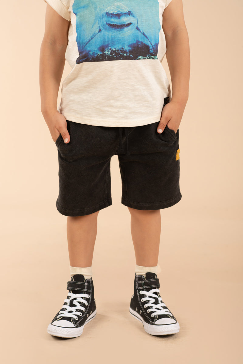 Child wearing the ROCK YOUR BABY Vintage Black Track Shorts