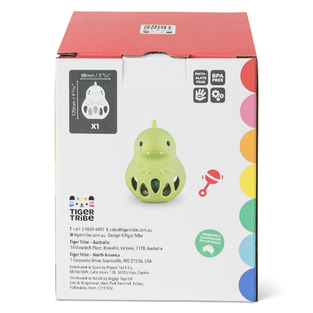 Green toy with packaging featuring colorful circles and text on a white background