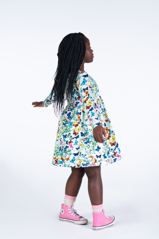 Side view of Girl wearing the ROCK YOUR BABY Butterflies Dress
