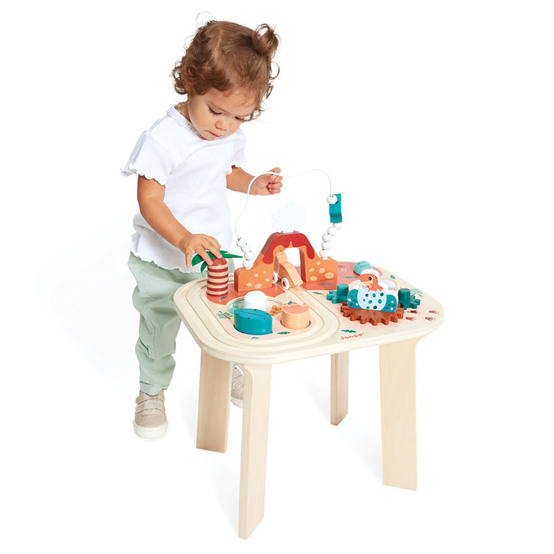 Toddler playing with the JANOD Dino Activity Table 