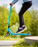 Person riding a blue scooter with 'Ramp' branding outdoors.
