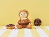 OLLI ELLA Dinky Dinkum Doll Darcy Donut sitting next to donuts
