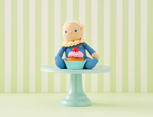 OLLI ELLA Dinky Dinkum Doll Bonnie Buttercream sitting on a cake stand