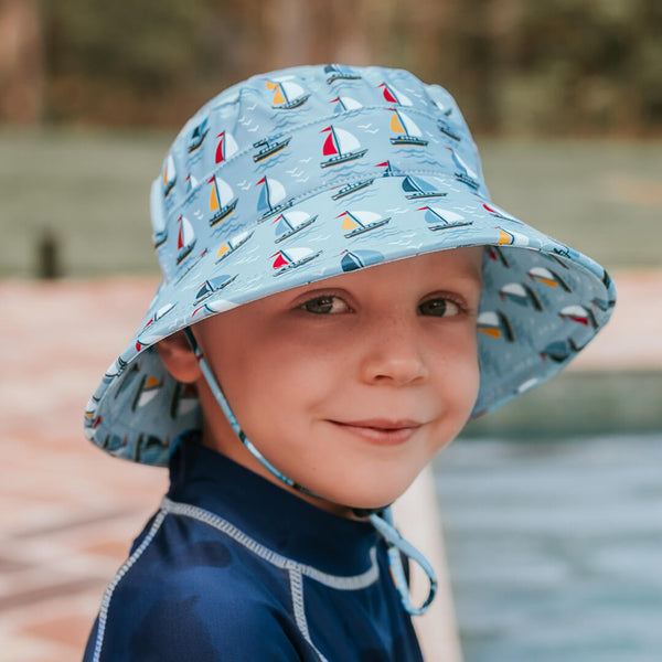 Child wearing BEDHEAD HATS Kids Classic Bucket Beach Hat - Sails - side view
