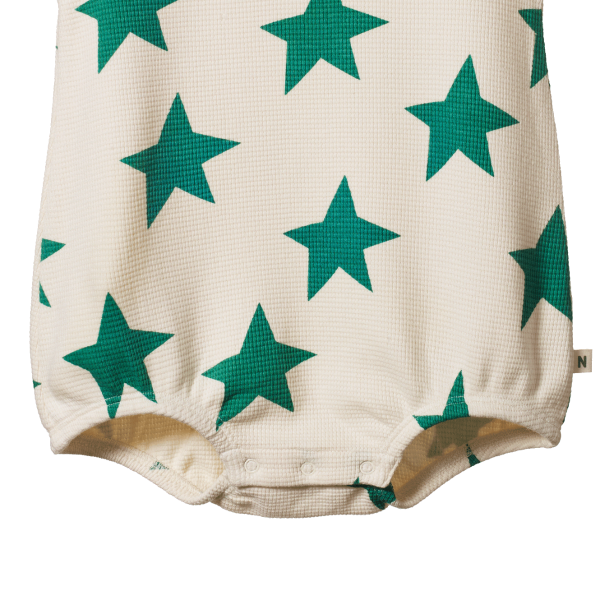 Baby romper with green star pattern on a white background