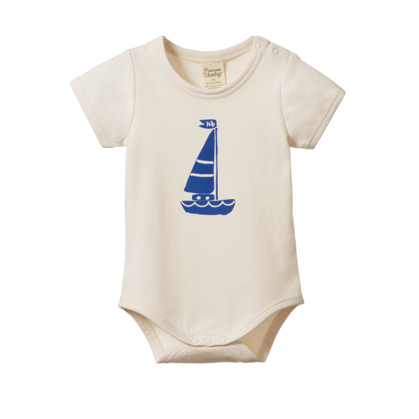 Beige baby onesie with blue sailboat design on a white background
