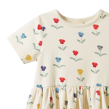 Beige dress with colorful floral patterns on a white background