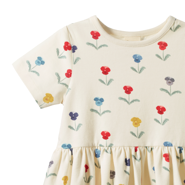 Beige dress with colorful floral patterns on a white background