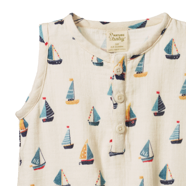 Baby romper with sailboat pattern on a white background