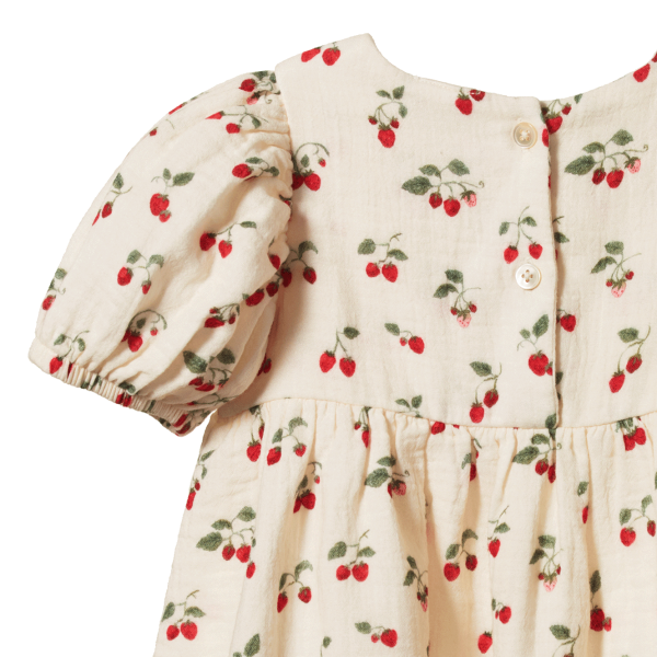 Back view of Children's dress with strawberry pattern on a white background