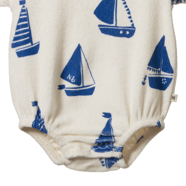 Baby romper with blue sailboat pattern on a white background