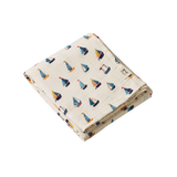 Folded fabric with sailboat pattern on a white background