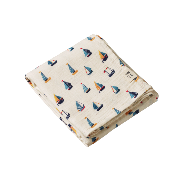 Folded fabric with sailboat pattern on a white background