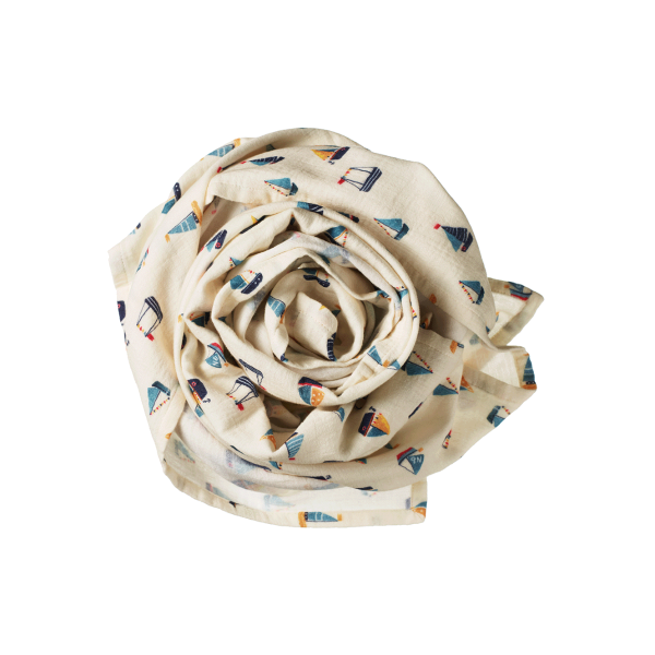 Rolled-up fabric with sailboat pattern on a white background
